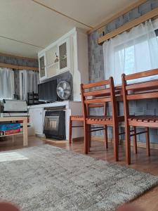 a living room with two chairs and a fireplace at Domek nad jeziorem Gopło Jacuzzi & Sauna - Połajewo in Połajewo