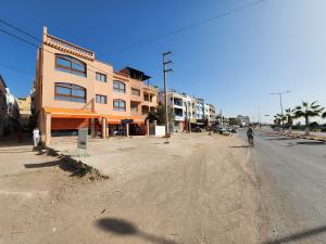 an empty street with a person riding a bike at Quadra Sphere in Tamraght Ouzdar