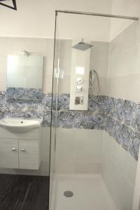 a bathroom with a shower and a sink at D&C House in Galatone +19 photos