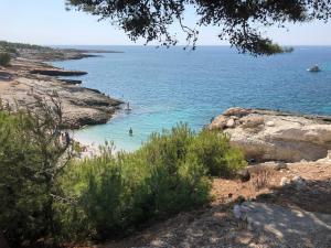 a beach with people swimming in the water at Petit Nid Pieds dans l'eau in Sausset-les-Pins +3 photos