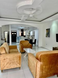 a living room with two couches and a table at Azar Stays Diani in Diani Beach +53 photos