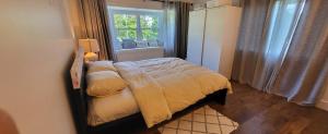 a small bedroom with a bed and a window at Sea view stay in Lantzville