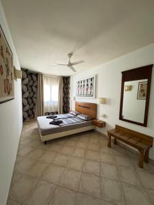 a bedroom with a bed and a table in it at Tropical Casa Castanha in Santa Maria +6 photos