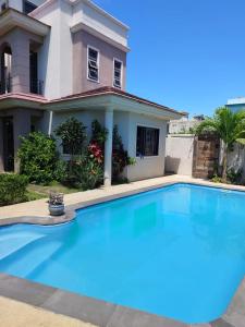 a large swimming pool in front of a house at Villa Azalea in Grand Baie