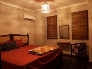 a bedroom with a bed and a mirror and a lamp at Villa Azalea in Grand Baie +19 photos