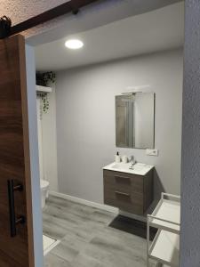 ein Badezimmer mit Waschbecken und Spiegel in der Unterkunft Lar de Yago - Apto Barreiros B in San Cosme de Barreiros + 10 Fotos