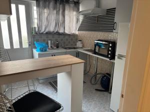 a kitchen with a sink and a microwave at Haus Rosi in Rhodes Town