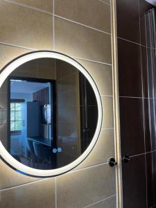 a mirror on a wall in a bathroom at Penzión u Kastelána in Spišské Podhradie