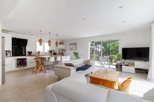 オーズヴィル・トロザーヌにあるMaison avec piscine, au calme près de Toulouseのリビングルーム(白い家具付)、キッチン