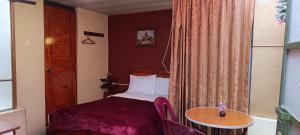 Postel nebo postele na pokoji v ubytování Hostal Sumak'usi