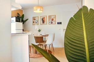 a kitchen and dining room with a table and a plant at Lunaria Living I VW Tor 17 - Gemütlich - Home Office - Zentral - Parkplatz in Wolfsburg +23 photos