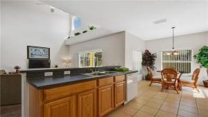a large kitchen with a sink and a table at Kissimmee in Kissimmee