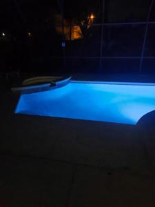 a swimming pool at night with blue illumination at Kissimmee in Kissimmee