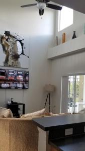 a living room with a ceiling fan and a table at Kissimmee in Kissimmee