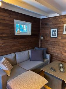 a living room with a couch and a table at Modern cabin in amazing hiking area! in Gol