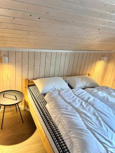 a large bed in a room with a table at Modern cabin in amazing hiking area! in Gol