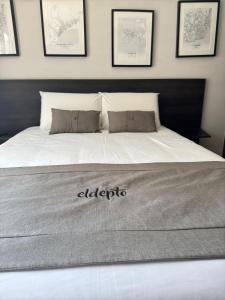 a bed with an alberbyte sign on top of it at ELDEPTO Padre Mariano Apart Hotel in Santiago