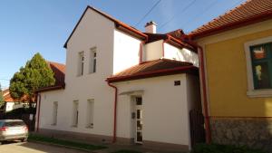 a white house with a red roof at Bike apartman in Esztergom