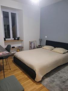 a bedroom with a large bed and a table at Hellfest 2025 chambre petit-déjeuner in La Celle-sous-Gouzon