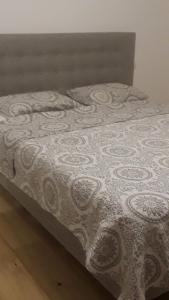 a bed with a white blanket on top of it at Hellfest 2025 chambre petit-déjeuner in La Celle-sous-Gouzon