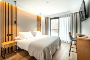 a bedroom with a bed and a desk and a television at Centrotel Zamora in Zamora +66 photos