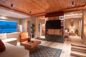 a living room with a couch and a tv at Rivage Resort Skardu in Shigar