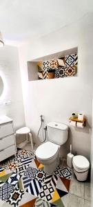 a bathroom with a toilet and a mosaic floor at La Tienda de Miguel in El Chorro