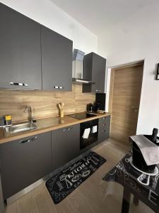a kitchen with a sink and a counter top at LORY ROOM vacation home in Quartu SantʼElena
