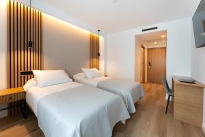 Ένα ή περισσότερα κρεβάτια σε δωμάτιο στο Centrotel Zamora