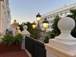 a balcony with street lights and a building at Sherryflat Terraza San Francisco in Jerez de la Frontera
