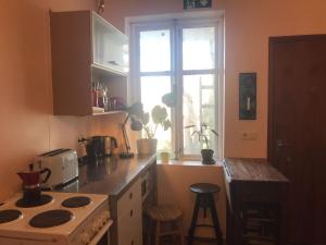 a kitchen with a stove and a window at Solkot Cottage Homestay in Reykjavík