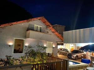 a house with two cars parked in a parking lot at night at Casa Barbosa Paraty in Paraty