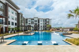 an image of a swimming pool at a apartment complex at Luxury Apartments Near Airport in Austin
