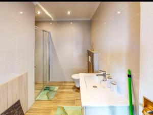 a bathroom with a white sink and a toilet at Retro Boutique in Cape Town