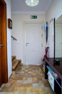 a hallway with a white door and a tiled floor at Apartment Rincón de Marinos in Almuñécar +46 photos