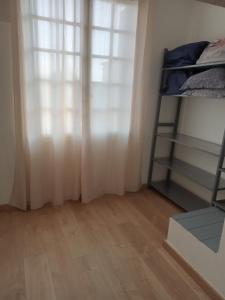 a bedroom with a window and a bunk bed at Chez Manon in Millas