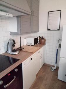 a kitchen with a counter top with a microwave at Chez Manon in Millas