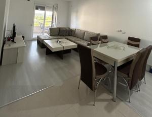 a living room with a couch and a table at Apartman Marika in Gevgelija +4 photos