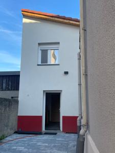 a white building with a door and a window at Cozy Studio in a central and quiet area near Basel in Saint-Louis