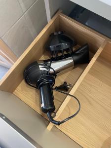 a hair dryer sitting in a wooden drawer at Cozy Studio in a central and quiet area near Basel in Saint-Louis