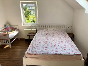 a small bedroom with a bed and a window at Storchennest - Ferienappartement mit Kamin, Sauna, Garten, E-Piano in Putlitz