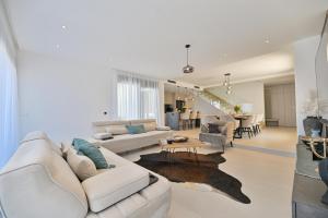 a living room with a white couch and a table at Villa Oasis in Trogir
