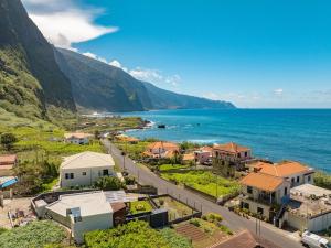 an aerial view of a small town next to the ocean at Fajã Lodges - Studio Ash in São Vicente