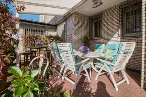 a patio with blue chairs and a table on a patio at Hotel Zum Eisenhammer in Oberhausen