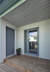 a door on the side of a house with a porch at Apartment Hakalahdenkatu in Kokkola