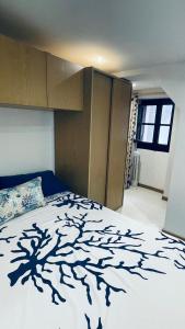 a bedroom with a bed with a tree pattern on it at Dreaming Cefalù in Cefalù
