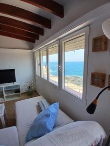 a bedroom with a bed and a view of the ocean at Primera línea de playa en Villaricos in Villaricos +20 photos