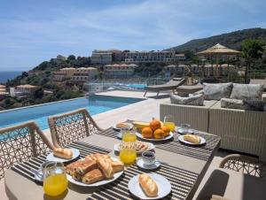 a table with breakfast food on top of a balcony at Tsimaras Villa II in Kefallonia +39 photos