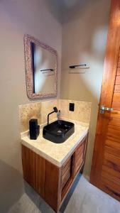 a bathroom with a black sink and a mirror at Vila São Jorge in Barra Grande +105 photos