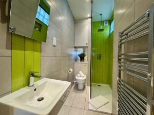 a bathroom with a sink and a toilet at Allards Apartment, Central Tynemouth in Tynemouth